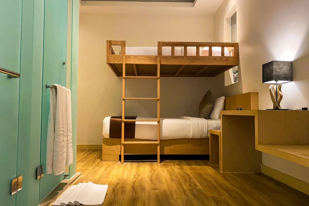 Second bedroom with wooden bunk beds in the Family Pool Villa at Crest Resort, suited to families with children