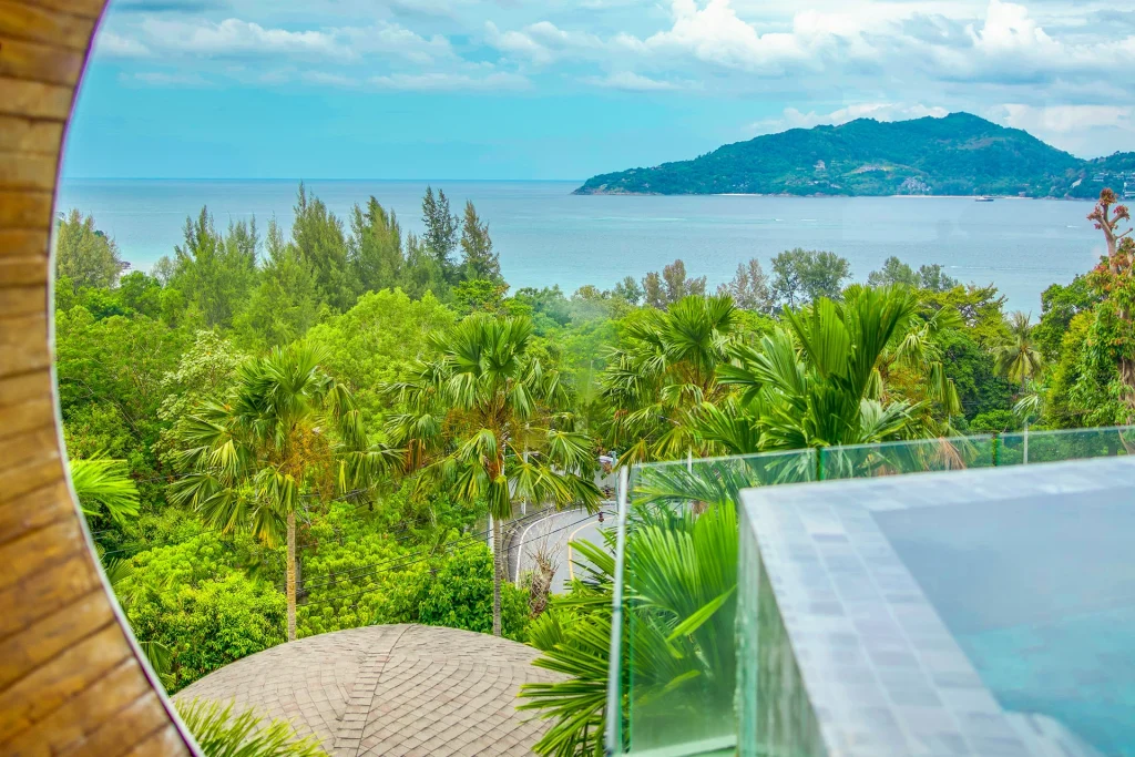 Sea view over green hillside from the private pool terrace of a Premier Panorama Pool Villa above Patong