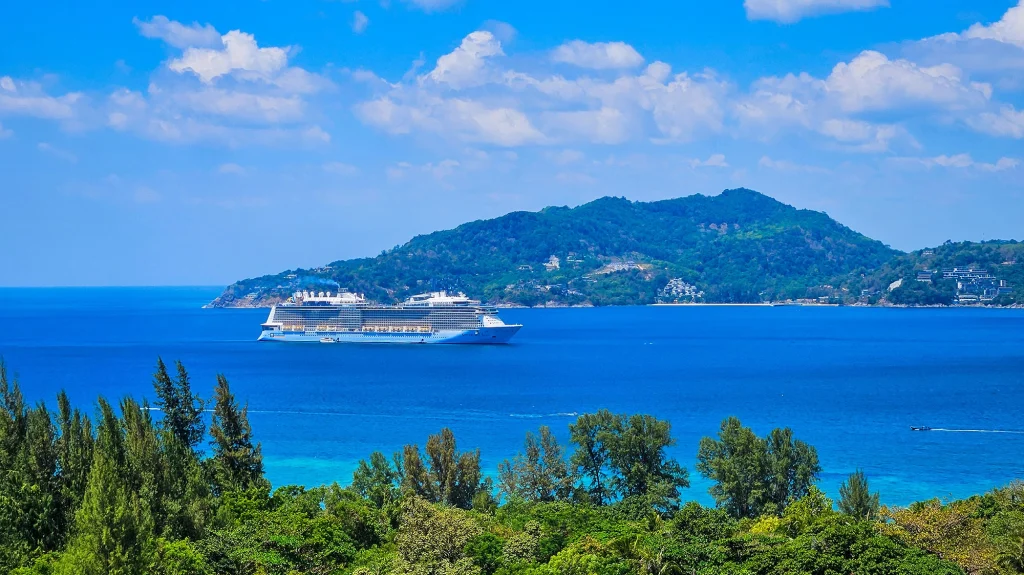 Cruise ship anchored in the bay below the green hills around Crest Resort near Patong, Phuket