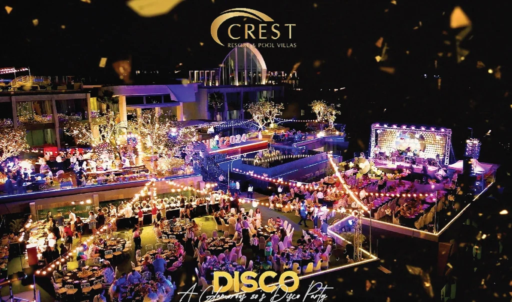 Night-time aerial view of the 2024 New Year's Eve disco party with a stage and dining tables at Crest Resort