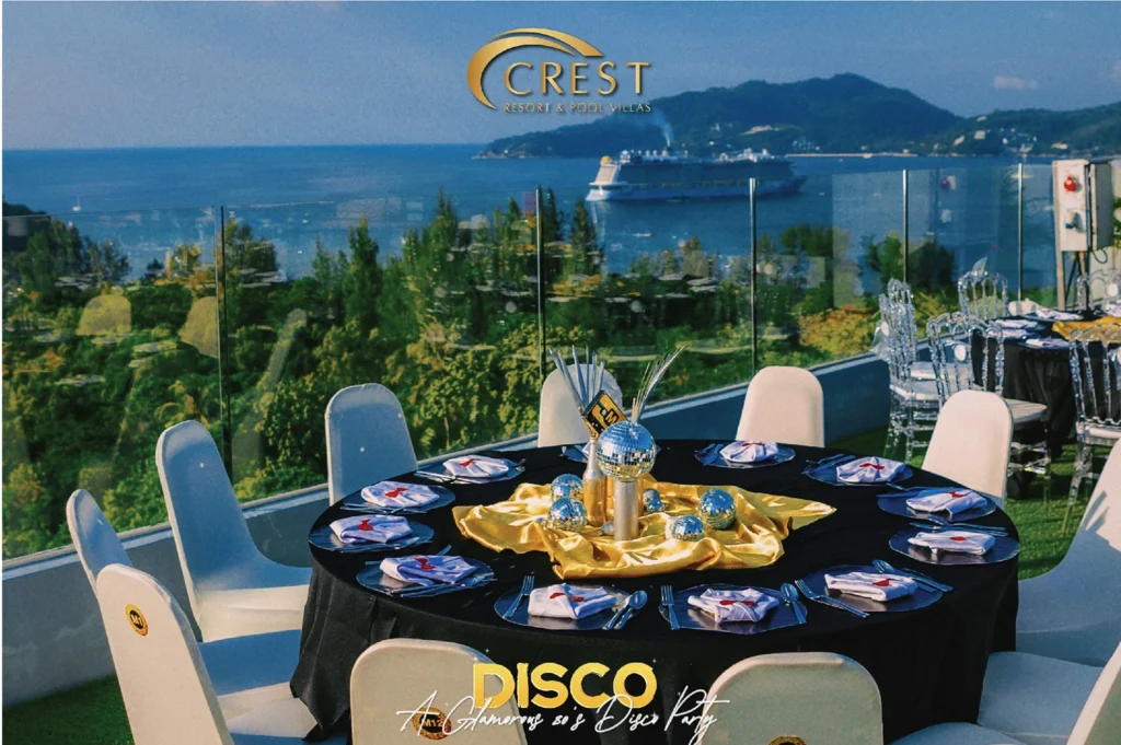 Round dinner table set for the New Year's Eve 2024 party on a sea-view terrace at Crest Resort, with the Andaman Sea behind